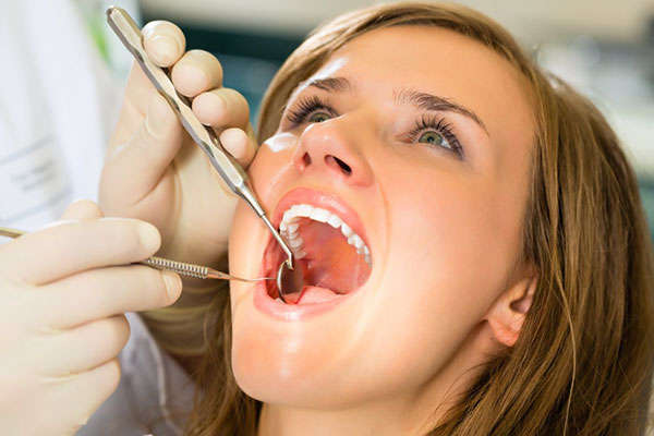 Woman getting dental work done