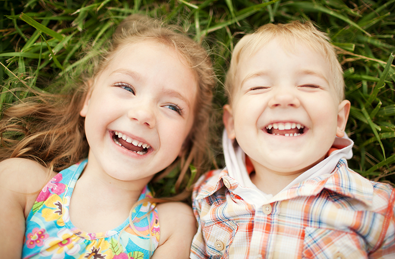 Kids Laughing in Grass
